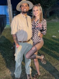 a man standing next to a woman on top of a grass covered field at night