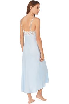 This soft satin nightgown is the definition of chic, designed with a flattering drape and a delicate neckline of floral netting lace. Straps are adjustable. For a stunning set, pair it with the matching Santorini Satin Wrap Robe. Style Number: E5220075-111 and E5220075-450 Length: 53" 100% PolyExclusive of ornamentation Model is wearing size S. She is 5'9.5", Bust 34", Waist 24", Hips 35" Imported Satin Night Dresses With Delicate Straps, Feminine Lace Gown With Lace Trim, Night Dress With Delicate Satin Straps, Satin Dress With Delicate Straps For Night, Satin Dress With Lace Back For Wedding Night, Elegant Night Dresses With Lace Bodice, Elegant Lace Nightgown With Delicate Lace, Sheer Satin Sleep Dress, Satin Lace Bodice Night Dress