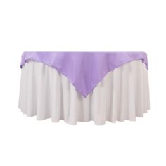 a purple and white table cloth on top of a round tablecloth with pleated edges