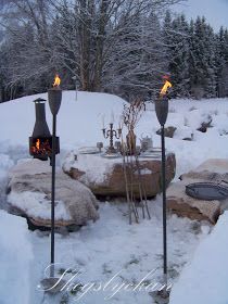 a fire pit surrounded by snow covered rocks