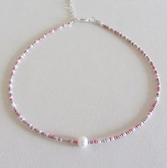 Beaded choker Pearl bead choker White pink silver rainbow delicate beaded choker necklace Adjustable pearl choker single pearl necklaces Free shipping is available for orders to the United States, with a purchase of $ 35. This beautiful necklace is made of white, pink and silver beads with one freshwater pearl. Please choose at an order length of necklace. Each choker comes with a 2 inch adjustable extender chain. Rainbow Pearl Necklace, Pink Choker Necklace, Pink Beaded Necklace, Choker Pearl, White Choker, Pink Choker, Choker Necklace Designs, Single Pearl Necklace, Rainbow Pearl