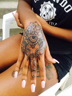 a woman's hand with an elephant tattoo on it