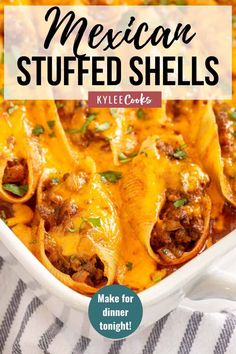 mexican stuffed shells in a white casserole dish with cheese and meat on top