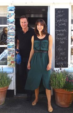 a man and woman standing in front of a store