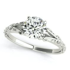 a white gold engagement ring with an intricate design