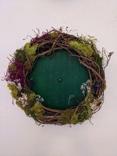 a green door with moss growing on it