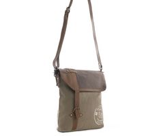 This bag hearkens to exotic adventures and a great style you'll love! Sandstone upcycled woven military canvas and caramel leather merge perfectly. Special overprinting hearkens to travel abroad, while an extra zippered pockets on the back adds convenience. The durable shoulder strap is in matching leather. More Information Materials Canvas & Leather Item Width 12.5 Item Depth 2.5 Item Height 11.5 Shoulder 22 Khaki Canvas Bag With Zipper Closure, Adventure Khaki Bags With Waxed Finish, Khaki Adventure Bags With Waxed Finish, Khaki Adventure Bag With Waxed Finish, Outdoor Canvas Satchel With Zipper Closure, Khaki Waxed Finish Adventure Bag, Outdoor Shoulder Bag With Adjustable Strap In Coated Canvas, Brown Canvas Bag With Zipper For Outdoor Use, Khaki Canvas Travel Bag With Adjustable Strap