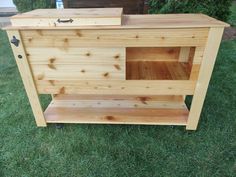 a small wooden bar on wheels in the grass