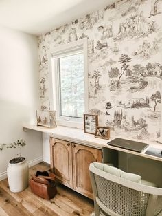 a kitchen with a sink, window and wallpaper