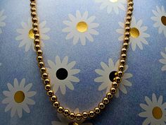 "Circa 1970, a 14.5\" long 14k yellow gold 4mm bead choker style necklace. Stamped 14k and hallmarked C+K. Weight is 11.6 grams. Condition is very good. Thanks for looking.    ERA - Circa 1970 , Vintage METAL / MATERIAL - 14k yellow gold  MARKINGS / HISTORY - Stamped 14k and hallmarked C+K.  CONDITION - The overall condition is very good! A true representation of 1970s-era jewelry! SIZE / MEASUREMENTS - Size: 14.5\" inches long / 4mm bead / Weight is 11.6 grams.  VINTAGE/ANTIQUE/HANDMADE - This Gold Beaded Round Choker, Classic Gold Beaded Necklace, Classic Gold Beaded Necklaces, Gold Choker With Round Beads, Gold Round Beads Choker As Gift, Gold Choker With Round Beads As Gift, Adjustable Gold Choker With Round Beads, Adjustable Gold Choker With Spacer Beads, Gold Single Strand Beaded Necklace For Gift