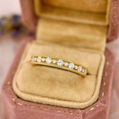 Crafted entirely from 14K solid gold, this dainty stackable ring adds a touch of elegance to any ensemble.  ♡ Features  * Gold Kt: 14K Solid Gold * Available Gold Color: Yellow Gold * Ring Size: 3 1/2 - 8 1/2 US/CA * Gemstone: Cubic Zirconia, can be customized with Moissanite * Stone Color: Flawless D Color * Stone Cut: Round Cut * Band Width: 2.6mm * Stamped with 14K (AU585) hallmark  ♡ Shipping & Returns Orders placed Monday - Friday will ship within 3-7 business days. Please contact us if you Elegant Gold Stackable Diamond Ring, Dainty 14k Gold Round Cut Eternity Band, Dainty Half Eternity Band, Stackable Yellow Gold Wedding Ring, Classic 14k Gold Half Eternity Stackable Rings, Dainty Eternity Band For Formal Occasions, Classic Gold Diamond Ring With Half Eternity, Delicate Yellow Gold Stackable Rings, Classic Gold Stackable Rings For Anniversary