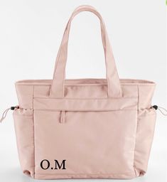 The Movement collection features a line-up of relaxed silhouettes, all designed for casual accessorising. Lightweight fabric and contemporary colours make every piece easy to use and effortless to style. This oversized tote boasts multifunctional pockets, including a padded laptop compartment, making it a true everyday essential. Toggle fastenings are inspired by premium outdoorsy brands, adding a touch of laid-back luxury. Made from 100% recycled polyester, the collection is another active step On-the-go Shoulder Bag With Functional Pockets And Double Handle, Sporty Everyday Bags With Functional Pockets, Modern Bags With Pockets For On-the-go, Functional Tote Bag With Multiple Pockets, Casual Travel Bag With Zipper Pocket And Double Handle, Everyday Bags With Functional Pockets And Softback, Versatile Tote Shoulder Bag With Functional Pockets, Daily Use Tote Gym Bag With Functional Pockets, Functional Double Handle Shoulder Bag With Pockets