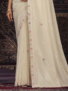 Introducing an exquisite off-white georgette saree that epitomizes elegance and grace, perfect for weddings, festivals, parties, and other special occasions. This beautiful saree is meticulously crafted from high-quality silk georgette fabric, combining the softness of silk with the lightweight and flowy texture of georgette. The off-white hue adds a touch of sophistication, making it a versatile addition to your ethnic wardrobe.
The saree is adorned with intricate sequin work, which shimmers de Elegant White Pre-draped Saree For Eid, Festive Cream Pre-draped Saree With Cutdana, Elegant Off White Pre-draped Saree For Festive, Festive Semi-stitched Cream Pre-draped Saree, White Pre-draped Saree With Zari Work For Eid, Elegant White Pre-draped Saree With Sheer Dupatta, Festive Off White Pre-draped Saree, Elegant White Pre-draped Saree For Festivals, Elegant White Pre-draped Saree For Wedding