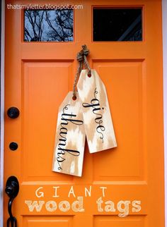 an orange door with two tags hanging from it's side and the words, giants are wood tags