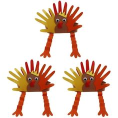 three red and yellow hand puppets with one wearing a crown on it's head