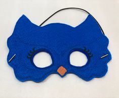 "Blue Owl Masks. Great for dramatic play/dress-up. Fun mask for Halloween or Cos Play. These masks would make a fun party favor or fun addition to a themed birthday party. Need a larger quantity than what I have listed? Message me. I can usually accommodate larger orders. These masks are made from felt. The details are machine embroidered. The masks include a 13\" elastic strap. This size typically fits from age 3 to small adult. This mask measures approximately 7 by 5 inches. These items can be Superhero Masks For Halloween Masquerade, Fun Party Masks For Carnival, Superhero Style Masquerade Masks For Halloween, Blue Costume Accessories For Halloween, Fun Carnival Party Masks, Fun Party Mask Costume Accessory, Themed Blue Costume Accessories For Party, Playful Masquerade Masks For Halloween, Playful Halloween Masquerade Masks