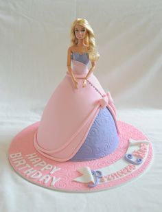 a barbie doll birthday cake on a white background