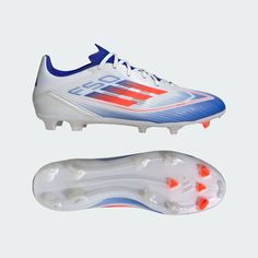 a pair of white and blue soccer shoes with orange accents on the outseats