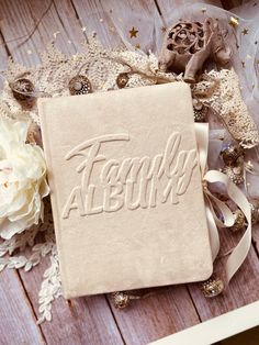 a personalized wedding ring pillow on a table with flowers and laces around it