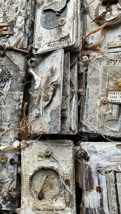 many old books are stacked on top of each other with tags attached to the covers