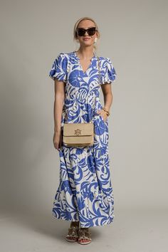 A proven, best-selling maxi, now offered in a chic new print! Dress features a notch neckline, and the cinched elastic waistband that flows into a tiered maxi skirt. A ruffled collar and short puff sleeves create a sweet, feminine look.  Pull-on fit Side pockets Partially lined below the waist Elastic sleeve cuff Cinched elastic waistband Fabric content: Self- 83% rayon, 17% nylon. Lining- 100% rayon Fabric has no stretch... Chic Short Sleeve Maxi Dress With Ruffle Hem, Short Sleeve Maxi Dress With Ruffles For Day Out, Summer Maxi Dress With Ruffle Hem And Short Sleeves, Blue Tiered Maxi Dress For Day Out, Off Shoulder Jacket, Athleisure Accessories, Tiered Maxi Skirt, Vest Blazer, Ruffled Collar