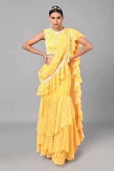 Mustard pre-draped saree with floral printed motifs and lace trim on the border. Comes with embroidered blouse.
Component: 2
Pattern: Embroidered and Print
Type Of Work: Floral Print, Beads and Thread
Neckline: Round
Sleeve Type: Sleeveless
Fabric: Georgette
Color: Yellow
Other Details: 
Saree with ruffle border
Cutwork blouse with shell hangings
Cutout back
Closure: Hook back
Occasion: Sangeet - Aza Fashions Cutwork Blouse, Draped Saree, Ruffle Saree, Drape Saree, Yellow Saree, Georgette Blouse, Blouse For Women, Saree With Blouse, Blouse Online