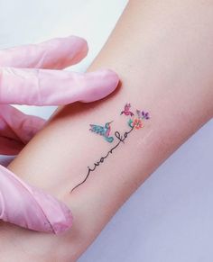 a woman's arm with butterflies on it and the word love written in cursive writing