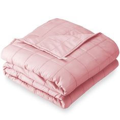 the pink comforter is folded up on top of the bed and ready to be slept in