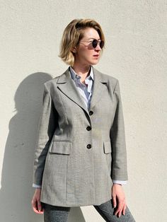 "Vintage Pablo Paris minimalist Dove grey blazer. The blazer is made of blended wool with shoulder pads and brown lining, 3 buttons fastening, two flap pockets and very elegant fit. It easily becomes a timeless item in your wardrobe.  Condition : good vintage condition Label: Pablo Paris Size: 44 Material: 60% wool, 38% polyester, 2% elastane. Lining: 100% acetate Measurements taken lying flat: Shoulders : 43 cm /17\" Pit to pit: 51 cm/20\" Sleeves: 60 cm/23.5\" Length: 76 cm/30\" For more information feel free to contact me." Tailored Single-breasted Blazer Dress With Suit Collar, Tailored Single-breasted Blazer Dress, Tailored Single Breasted Blazer Dress, Classic Single Button Career Blazer Dress, Tailored Single Button Blazer Dress For Career, Wool Career Blazer With Button Closure, Classic Single Button Blazer Dress For Career, Classic Single-breasted Office Blazer Dress, Tailored Single Button Blazer Dress For Office