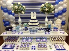 a table topped with lots of blue and white decorations