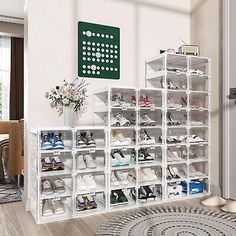 a white shoe rack filled with lots of shoes in a living room next to a door