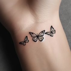 three butterflies tattoo on the left side of the arm and chest, with black ink