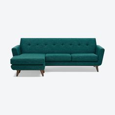 a green couch and ottoman sitting next to each other