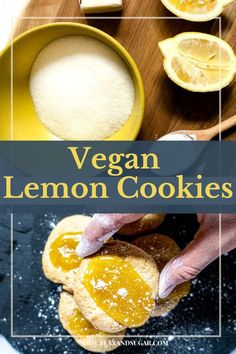 vegan lemon cookies on a cutting board with powdered sugar and sliced lemons