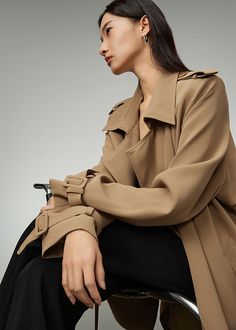 Elevate your outerwear game with the Daphne Khaki Double Breasted Trench Coat. This spring essential boasts a luxurious drape and timeless straight-cut design in a sophisticated khaki color. This mid-length coat is perfect for any occasion and adds an exclusive touch to your wardrobe. Double-breasted button closure Epaulets Notched lapels Front pockets Belted cuffs Long sleeves Lined Cotton, polyester, spandex Machine wash, tumble dry Women's trench coat Item #43702 SIZE INFO XS=US2=UK6=EU32 S=U Elegant Single Breasted Khaki Outerwear, Elegant Single-breasted Khaki Outerwear, Elegant Khaki Single Breasted Pea Coat, Elegant Single-breasted Khaki Pea Coat, Elegant Khaki Single-breasted Pea Coat, Elegant Khaki Outerwear With Lapel Collar, Classic Khaki Outerwear For Office, Khaki Long Coat With Hidden Button Closure, Khaki Long Coat For Office