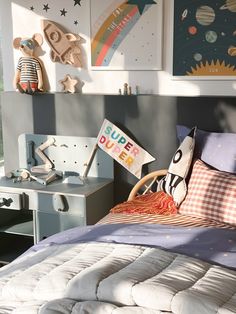 a child's bedroom with toys on the wall and in the background is a bed