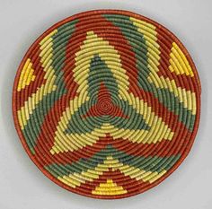 a woven basket is shown in red, yellow and green