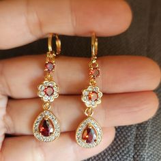 New 18k Gold Plated Pear Ruby Diamond Flower Dangle Drop Hoop Earrings For Women All Photos Are From The Actual Item No Stock Photo Used. Measurements Shown In The Pictures. All Items Comes With A Jewelry Box. Color May Slightly Differ Due To Lighting. All Gemstones Are Simulated. Please Feel Free To Ask Any Question About The Item. Please Check Out My Other Jewelry. Gold Teardrop Flower Earrings With Charm, Gold Teardrop Flower Charm Earrings, Teardrop Earrings With Flower Charm, Gold Teardrop Flower Earrings For Formal Events, Gold Teardrop Flower Earrings, Aesthetic Watches, Faberge Jewelry, Pink Stud Earrings, Arabic Henna