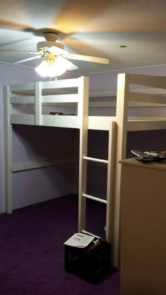 a room with bunk beds and purple carpeting on the floor in front of a ceiling fan