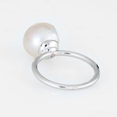 Finely detailed estate cultured pearl & diamond ring, crafted in 14 karat white gold.   The cultured pearl measures 10mm with a diamond inset into the pearl (estimated at 0.05 carats - H-I colour/VS2 clarity). The stones are in excellent condition and free of cracks or crisps.   The stylish high rising ring features a gemstone-in-gemstone design. The diamond is artfully bezel set into the pearl for a striking and unusual look . A great ring to wear alone or stacked with your fine jewellery from Formal White Pearl Ring, Modern Pearl Ring For Formal Occasions, White Pearl Drop Ring For Formal Occasions, White Akoya Pearl Timeless Ring, Timeless White Akoya Pearl Ring, Formal Pearl White Open Pearl Ring, White Akoya Pearl Ring With Pearl Drop, Formal Pearl White Open Ring, Classic White Pearl Ring With Charm