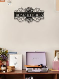 there is a table with some items on it and a sign that says rose kitchen