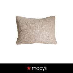 a white pillow with a black star on it and the words macy's written in red