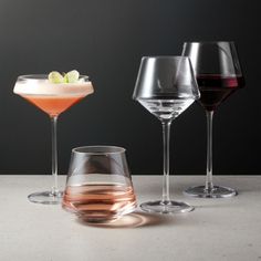 three different types of wine glasses on a table