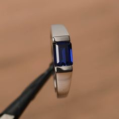 It is a lab sapphire ring. The main stone is 5mm*7mm emerald cut, weight about 1.16 carats.The basic metal is sterling silver and plated with rhodium.To change the metal to a solid gold (white/rose) or platinum is also available, please ask for a quotation if you want.You can also go to my shop Home for more elegant rings: https://www.etsy.com/shop/godjewelry?ref=hdr_shop_menu More sapphire rings: https://www.etsy.com/shop/godjewelry?ref=seller-platform-mcnav&section_id=20715031Customization Blue Sapphire Rings For Men, Sapphire Proposal Ring, East West Ring, Kids Ring, Tanzanite Rings, Elegant Rings, Simple Rings, Ring Inspo, Engagement Ring Photos