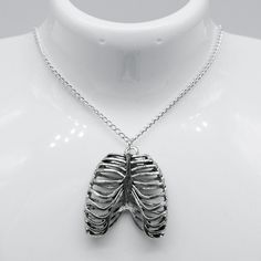 "Elevate your style with our Silver Gothic Rib Cage Charm Necklace! Crafted with intricately detailed rib cage charm in silver, this necklace is perfect for expressing your edgy and unique fashion sense. Make a bold statement and add a touch of gothic charm to any outfit. Good to Know: Nickle Free Charm Length 3.5cm Diameter 4cm Length  Dainty chain that can be worn at a variety of lengths Our Charm Necklaces look incredible with our stunning Circle Earrings! Unisex Silver Plated  Sizing Choker - 12-14\" (Extendable), Short necklace - 16\" Long necklace - 20\"" Gothic Choker Necklace, Charm Choker Necklace, Snake Ring Silver, Layered Necklace Set, Charm Necklace Silver, Dainty Chain, Good To Know, Charm Necklaces, Rose Quartz Gemstone