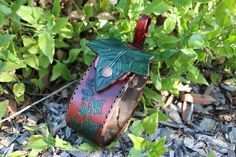 a red and green leather case sitting on the ground