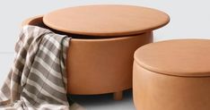 two stools and a table with a blanket on it next to eachother