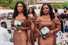 two bridesmaids in brown dresses standing next to each other at a wedding ceremony