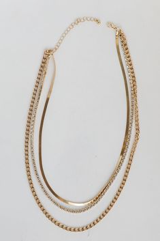 You'll be getting adoring looks left and right when you wear the Nova Gold Rhinestone Layered Necklace! This trendy necklace features three layers of gold chains with rhinestones. Style the Nova Necklace with any outfit to instantly add a chic touch to your look! Gold Plated Layered Rhinestones Snake Chain Lobster Clasp with Extender Layer 1 | Length 9" Layer 2 | Length 8" Layer 3 | Length 7.5" Extender | Length 3" Chic Gold Necklaces With Rhinestones, Gold Rhinestone Chain Necklace In Trendy Style, Trendy Gold Rhinestone Chain Necklace, Cute Necklaces, Trendy Necklace, Necklace Dress, Necklace Cute, Trendy Necklaces, Gold Necklace Layered