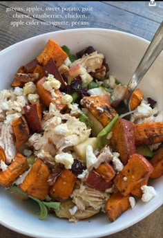 a white bowl filled with chicken and vegetables